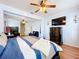 Bright main bedroom with hardwood floors, a ceiling fan, a TV, and access to an office area at 1602 Presidio Dr, Clermont, FL 34711
