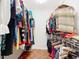 Packed walk-in closet with double rows of hanging clothing at 1602 Presidio Dr, Clermont, FL 34711