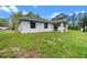 Exterior view of the backyard showing the lawn and covered patio at 1765 9Th Ave, Deland, FL 32724