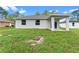 View of the backyard featuring a well maintained yard with new construction home in the background at 1765 9Th Ave, Deland, FL 32724