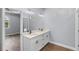 Bathroom featuring double sink vanity, wood look flooring, recessed lighting and a view of the bedroom at 1765 9Th Ave, Deland, FL 32724