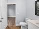 Bathroom with a toilet, sleek vanity, framed mirror, and view to bedroom at 1765 9Th Ave, Deland, FL 32724