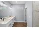 Bathroom featuring double sink vanity, wood look flooring, recessed lighting and a view of the marble shower at 1765 9Th Ave, Deland, FL 32724