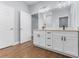 Bathroom vanity featuring dual sinks, white cabinets, and modern fixtures at 1765 9Th Ave, Deland, FL 32724