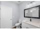 Bathroom featuring a modern sink, toilet, and dark-framed mirror, with tile floors at 1765 9Th Ave, Deland, FL 32724