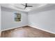 A bedroom features hardwood floors, modern ceiling fan, and a bright window overlooking the outdoors at 1765 9Th Ave, Deland, FL 32724