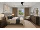 This is a cozy bedroom with neutral colors, a large window, and tray ceilings at 1765 9Th Ave, Deland, FL 32724