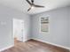 Bright bedroom boasts hardwood floors, a fan, and access to an en-suite bathroom at 1765 9Th Ave, Deland, FL 32724