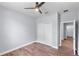 A bedroom featuring hardwood floors, a modern ceiling fan, and a double-door closet at 1765 9Th Ave, Deland, FL 32724