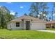 Attractive one-story home with a lush green lawn and an attached two-car garage at 1765 9Th Ave, Deland, FL 32724
