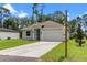 Charming single-story home with a well-maintained lawn and attached two-car garage at 1765 9Th Ave, Deland, FL 32724