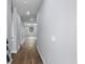 Inviting hallway with wood-look floors and neutral paint, leading to a bright living area at 1765 9Th Ave, Deland, FL 32724