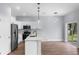 Stylish kitchen with stainless steel appliances, sleek white cabinets, and a view to the outdoors at 1765 9Th Ave, Deland, FL 32724
