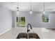 Modern kitchen featuring a center island with sink, stylish pendant lighting, and sliding glass doors at 1765 9Th Ave, Deland, FL 32724