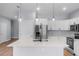Bright, open kitchen with white cabinetry, stainless steel appliances, and a large center island at 1765 9Th Ave, Deland, FL 32724