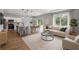 Bright living room featuring open floor plan to kitchen with modern furnishings and natural light at 1765 9Th Ave, Deland, FL 32724