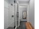 Bathroom with a glass shower, black tile flooring, and a rustic wooden bench at 2035 Dixie Belle Dr # 2035C, Orlando, FL 32812