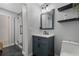 This bathroom features an updated vanity with marble countertop and glass shower with a dark tile floor at 2035 Dixie Belle Dr # 2035C, Orlando, FL 32812