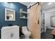 Bathroom with a barn door, walk-in shower, decorative mirror, and white vanity at 2035 Dixie Belle Dr # 2035C, Orlando, FL 32812