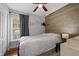 Bedroom featuring wood accent wall, natural light, and hardwood floors at 2035 Dixie Belle Dr # 2035C, Orlando, FL 32812