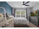 Comfortable bedroom with a ceiling fan, a window view, and a dresser with a TV at 2035 Dixie Belle Dr # 2035C, Orlando, FL 32812