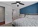 Well-lit bedroom featuring a ceiling fan, a window, and a crib next to the queen bed at 2035 Dixie Belle Dr # 2035C, Orlando, FL 32812