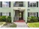 Apartment building entryway with outdoor stairs and a view through to the parking lot at 2035 Dixie Belle Dr # 2035C, Orlando, FL 32812