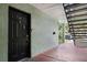 Close up view of a black front door and a small entryway of an apartment at 2035 Dixie Belle Dr # 2035C, Orlando, FL 32812