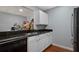 Kitchen with white cabinets and black granite countertops, with a kitchen pass-through at 2035 Dixie Belle Dr # 2035C, Orlando, FL 32812