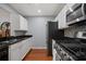 Kitchen with white cabinets, black granite countertops, stainless steel appliances and hardwood floors at 2035 Dixie Belle Dr # 2035C, Orlando, FL 32812
