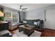 Bright living room with hardwood floors, a sectional sofa, a large window, and a ceiling fan at 2035 Dixie Belle Dr # 2035C, Orlando, FL 32812
