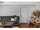 Cozy living room featuring hardwood floors, a gray sofa, and decorative vases at 2035 Dixie Belle Dr # 2035C, Orlando, FL 32812