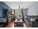 Comfortable living room with hardwood floors, a blue accent wall, a sectional sofa, and a ceiling fan at 2035 Dixie Belle Dr # 2035C, Orlando, FL 32812