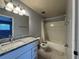 Bathroom featuring vanity with granite counters, updated fixtures, and tub with shower at 220 Cherokee Ct # 116, Altamonte Springs, FL 32701