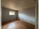 Cozy bedroom showcasing wood flooring, neutral walls, and a window at 220 Cherokee Ct # 116, Altamonte Springs, FL 32701