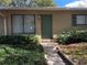 Charming front entrance with a teal door, well-maintained landscaping, and visible house number at 220 Cherokee Ct # 116, Altamonte Springs, FL 32701