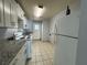 Functional kitchen with white cabinets, granite countertops, and essential appliances at 220 Cherokee Ct # 116, Altamonte Springs, FL 32701