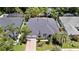 Aerial view of a single-story home with lush tropical landscaping and a brick-paved driveway at 2342 Northumbria Dr, Sanford, FL 32771
