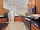 Open kitchen with stainless steel appliances and granite countertops provides ample space for cooking at 2342 Northumbria Dr, Sanford, FL 32771