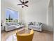 Bright living room featuring a large window, neutral furniture, and tile flooring at 2342 Northumbria Dr, Sanford, FL 32771