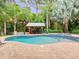 Inviting pool with a spa and a covered outdoor entertaining area surrounded by lush tropical landscaping at 2342 Northumbria Dr, Sanford, FL 32771