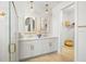 Bright bathroom with double sink vanity with gold hardware, glass enclosed shower, and linen closet in new home at 2727 Arbor Dune Ave, Apopka, FL 32712