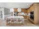 Modern kitchen with an island, stylish pendant lighting, stainless steel appliances, and ample cabinet space at 2727 Arbor Dune Ave, Apopka, FL 32712