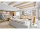 Open concept living room and kitchen featuring wood beam ceiling accents and lots of natural light at 2727 Arbor Dune Ave, Apopka, FL 32712