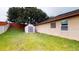 A well-kept backyard that contains a storage shed, grass lawn, privacy fence, and rear exterior of home at 3552 Macauley Ct, Ocoee, FL 34761