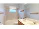 Bathroom with a tub and shower combo, dual sinks, and tiled walls at 3552 Macauley Ct, Ocoee, FL 34761