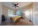 Charming bedroom with cozy carpet, a large window, and a ceiling fan at 3552 Macauley Ct, Ocoee, FL 34761