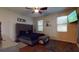 Bedroom with upholstered headboard, ceiling fan, television, and natural light from windows at 3552 Macauley Ct, Ocoee, FL 34761