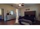 Stylish bedroom with a large bed, wood floors and a decorative mirror and dresser at 3552 Macauley Ct, Ocoee, FL 34761