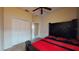 Cozy bedroom with a ceiling fan, double door closet and carpeted flooring at 3552 Macauley Ct, Ocoee, FL 34761